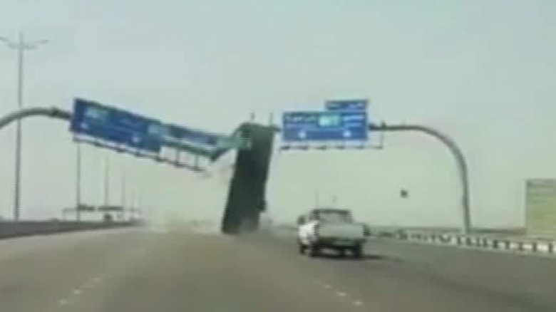Whoops! Dump truck takes out sign